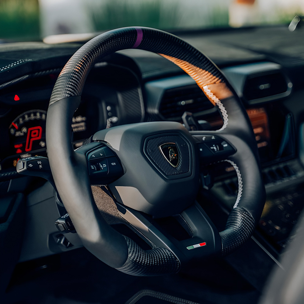 Customisable carbon fibre Lamborghini steering wheels with LED shift lights, alcantara, and carbon paddles