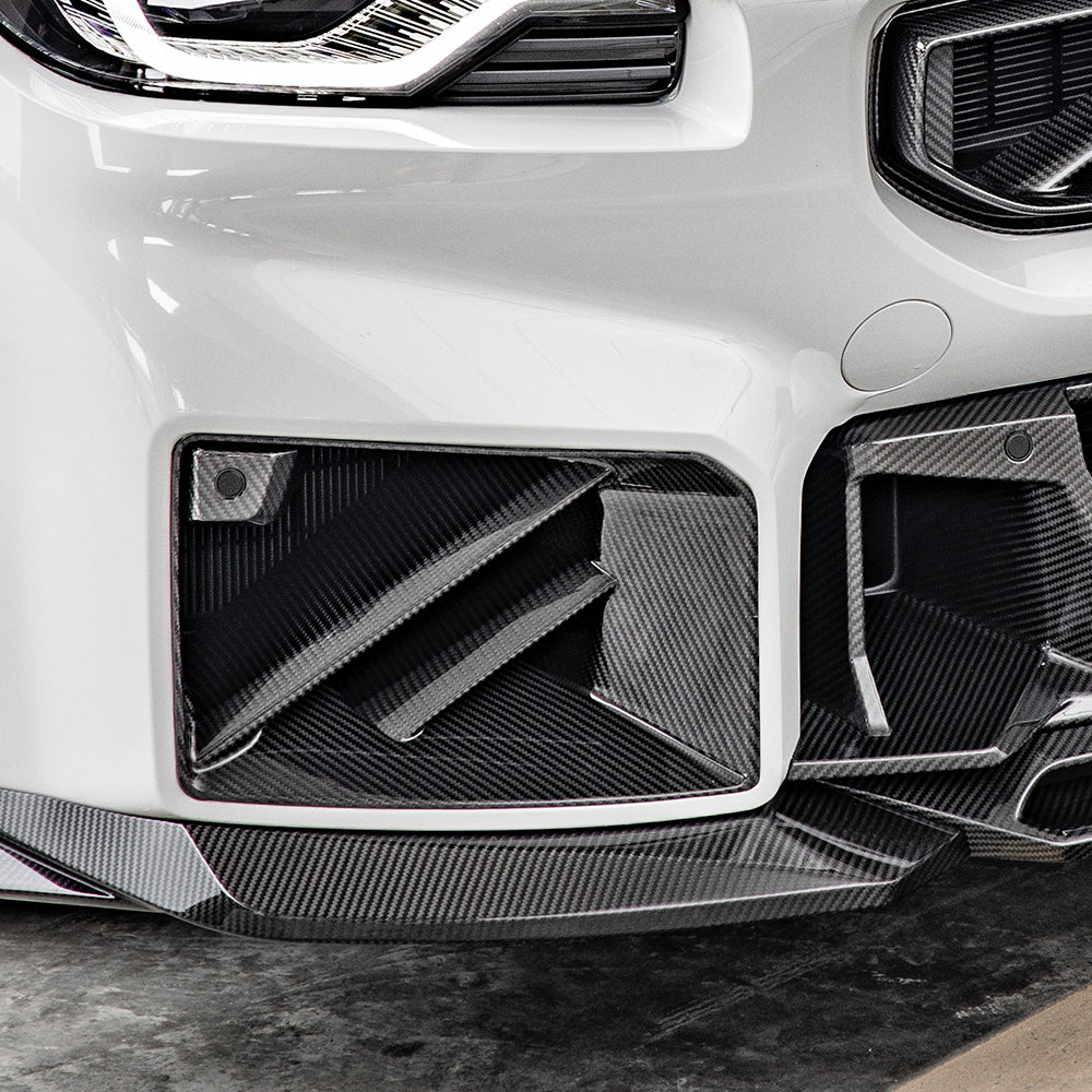 SOOQOO carbon fibre front ducts installed on BMW M2 (G87), front bumper close-up on white car