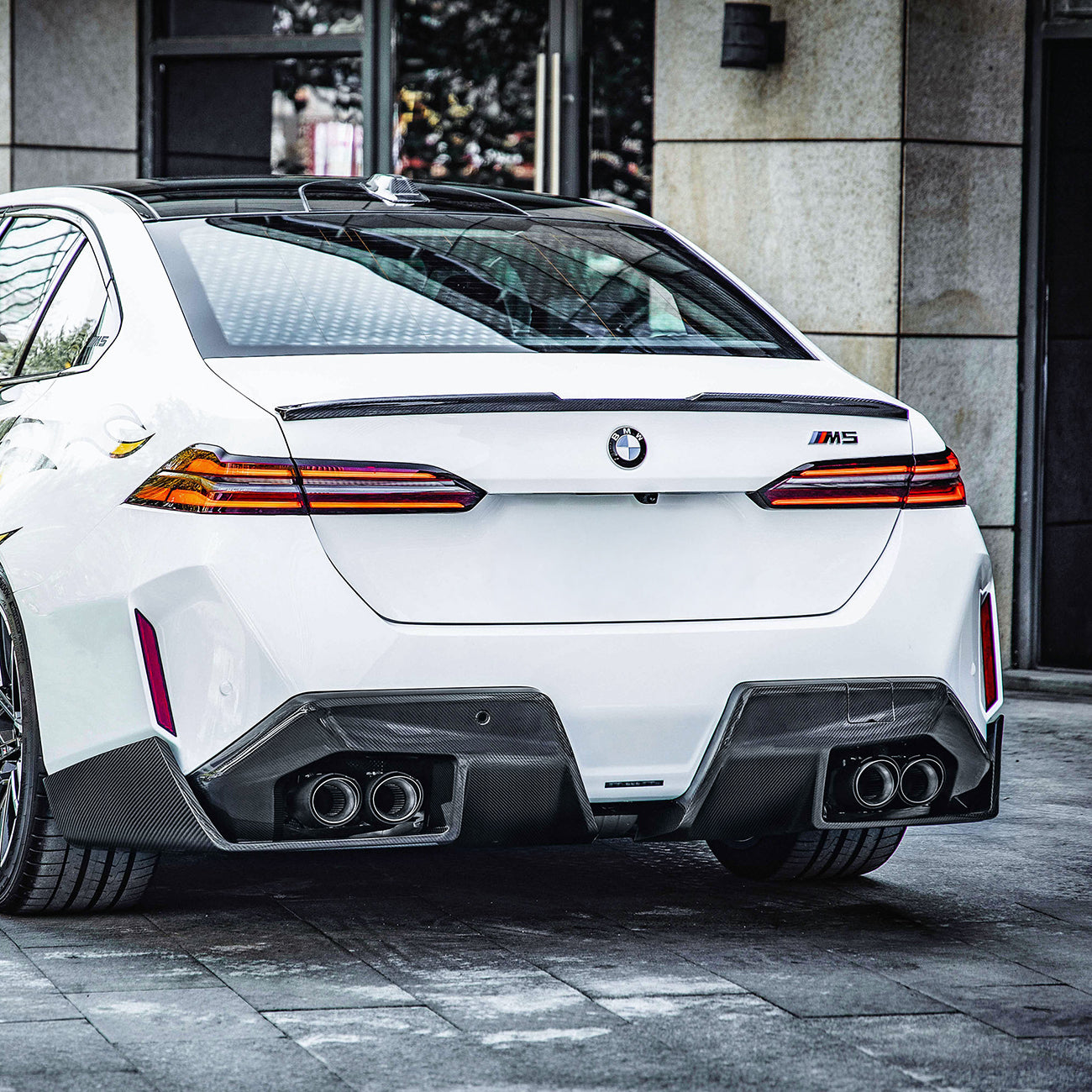 Angled side view of Carbon Fibre M Performance Rear Spoiler on BMW M5 G90