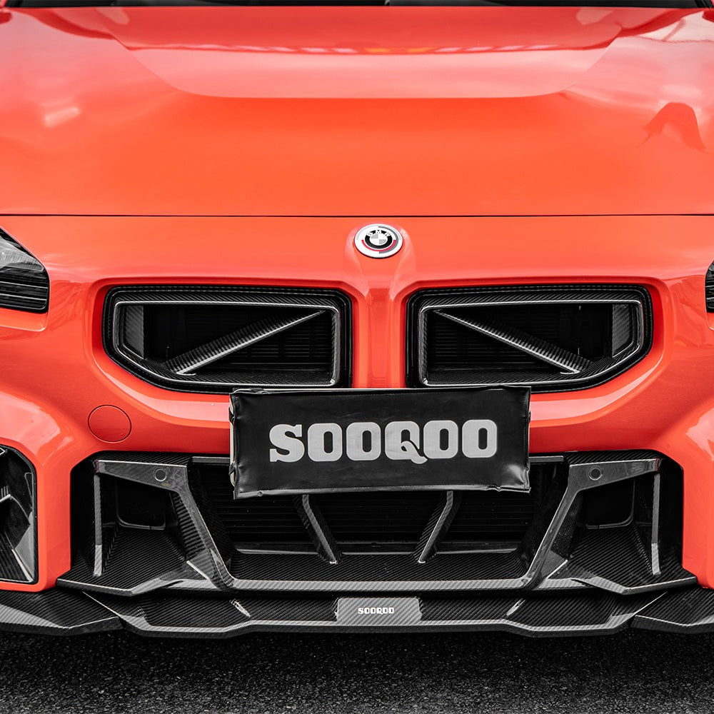 SOOQOO carbon fibre Front Grille V1 installed on BMW M2 (G87), straight front view on orange car