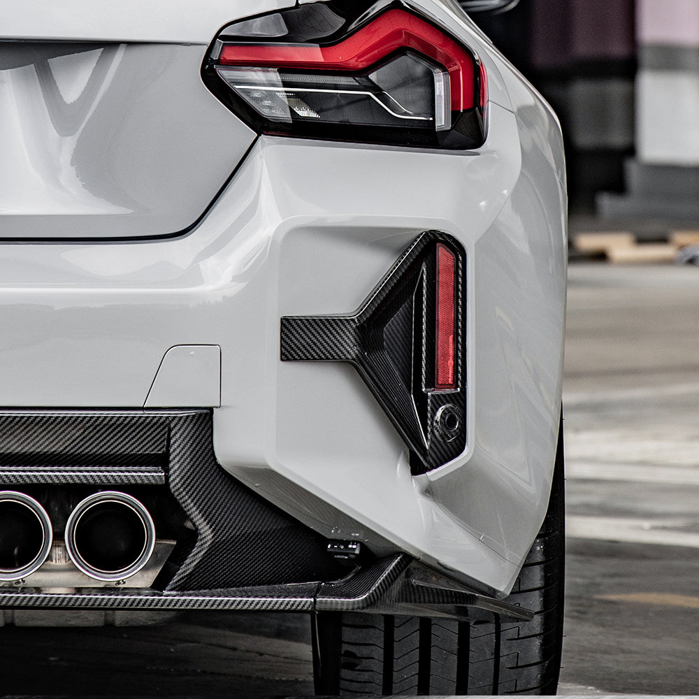 SOOQOO carbon fibre rear bumper inserts on BMW M2 (G87), rear corner close-up detail