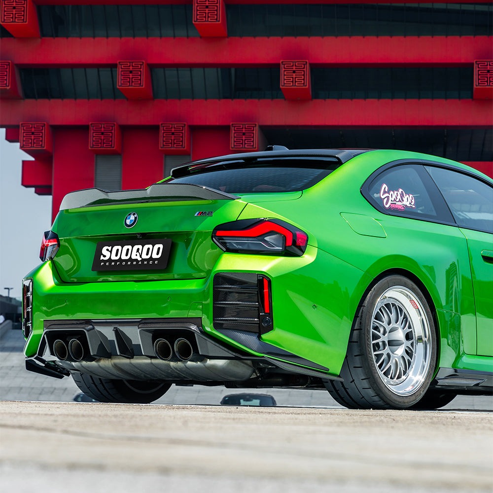 SOOQOO carbon fibre Rear Diffuser V2 installed on BMW M2 (G87), rear three-quarter view on green car