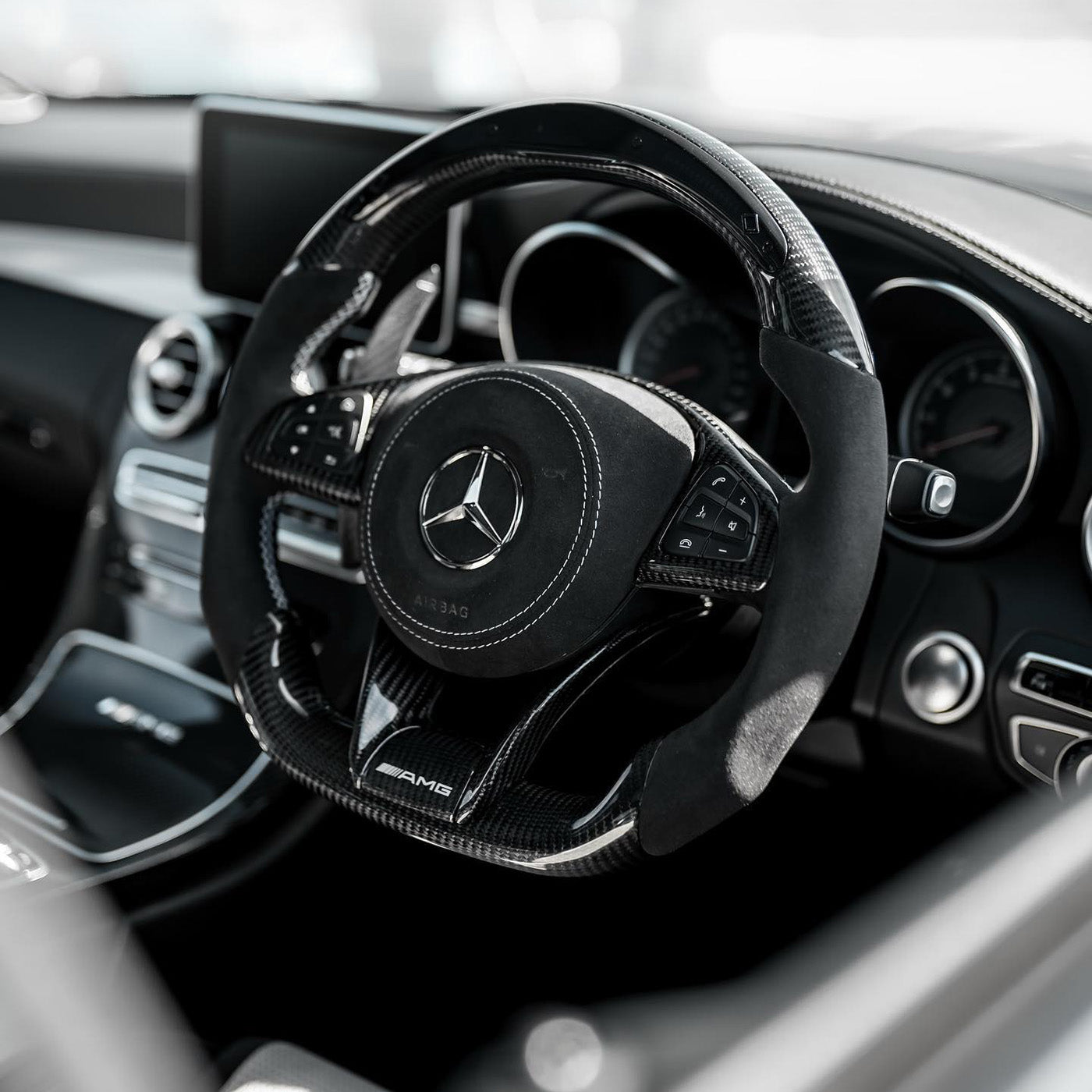 Custom carbon fibre Mercedes AMG steering wheel with Alcantara trim and performance detailing